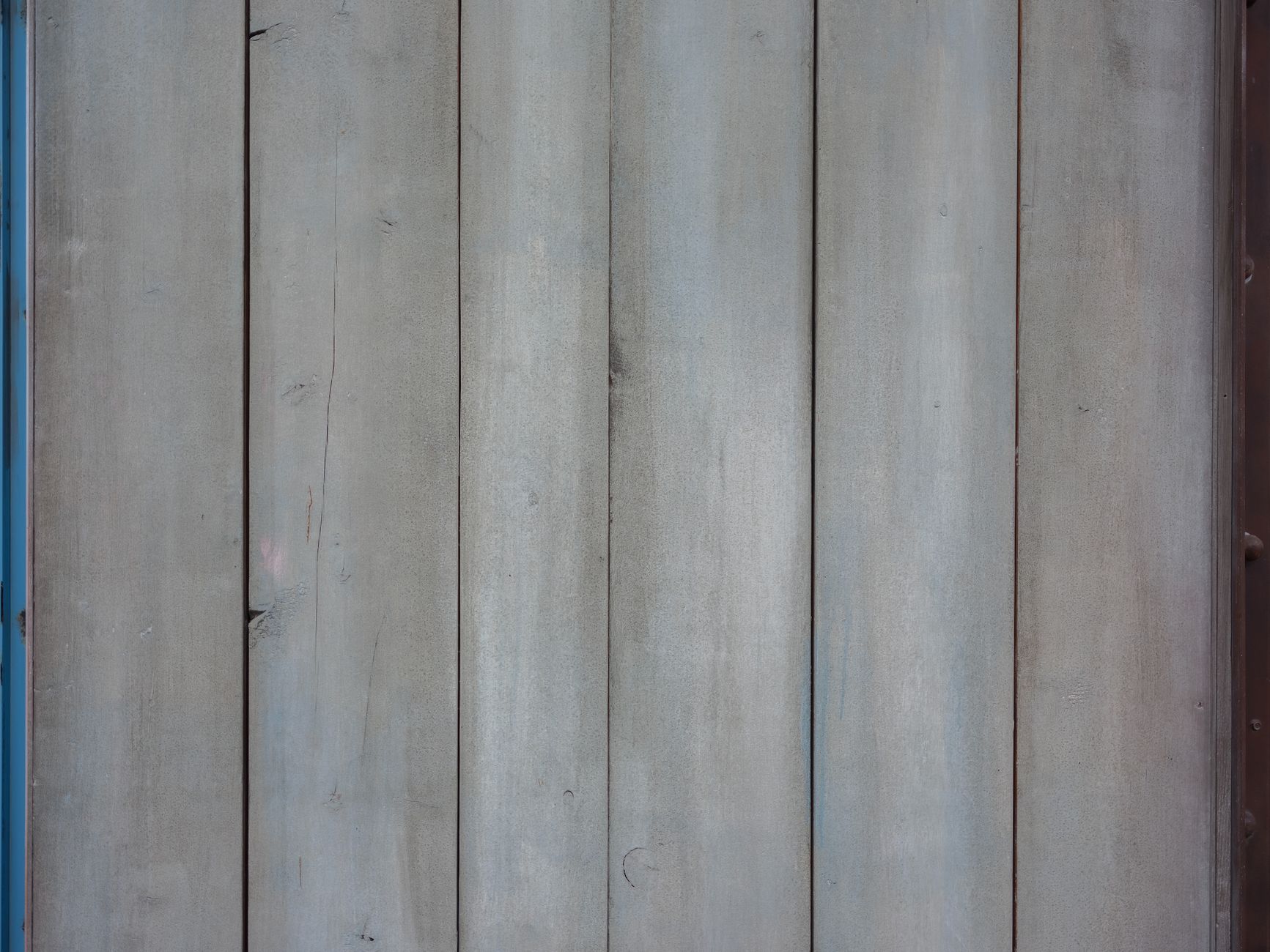 Weathered wooden fence planks arranged horizontally, showcasing natural grain and sturdy construction.